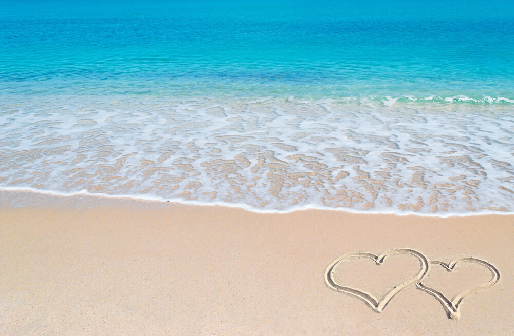 Hearts drawn on the beach during a romantic getaway in Alabama