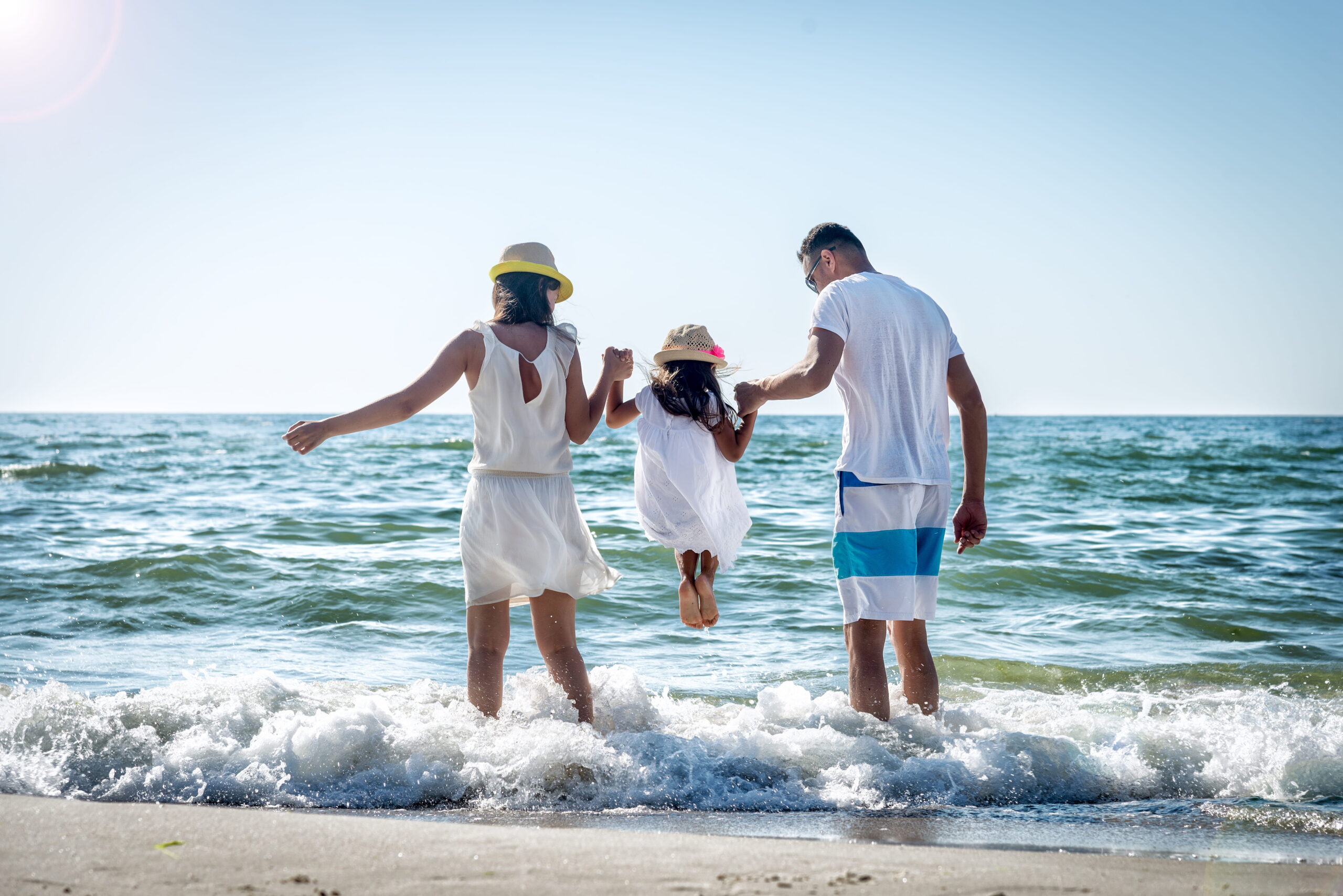 Family playing at the Dauphin Island beach on vacation